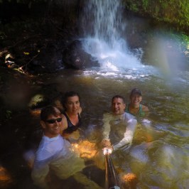 Jack Hoogendyk et al. standing next to a waterfall