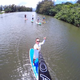 a man standing next to a body of water