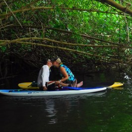 a man riding on the back of a boat in the water