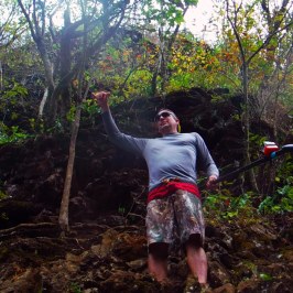 a man standing next to a forest