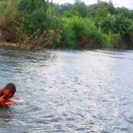a man standing next to a body of water