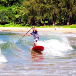 a person riding a surf board on a body of water