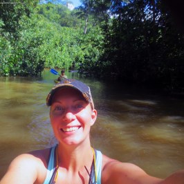 a woman standing next to a body of water