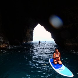 a person riding on the back of a boat in the water