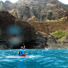 a body of water with a mountain in the background