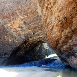 a person sitting on a rock in the water