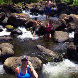a group of people standing next to a body of water
