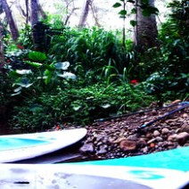 a man riding a surfboard on top of a rock