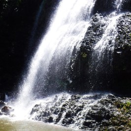a waterfall going over a body of water