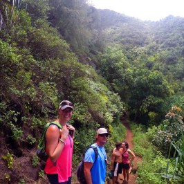 a group of people walking down a dirt trail
