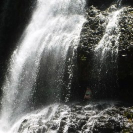 a large waterfall over some water