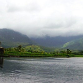 a body of water with a mountain in the background