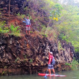 a group of people riding on the back of a boat on a river