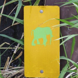 a yellow sign sitting on the ground