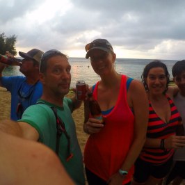 a group of people on a beach posing for the camera