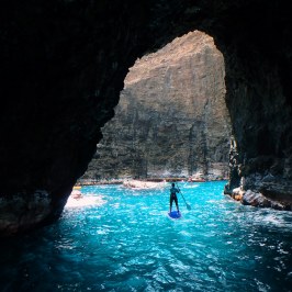 a cave next to a body of water