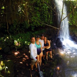 a person standing next to a waterfall