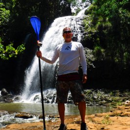 a man standing next to a tree