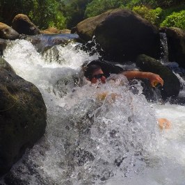 a man riding a wave on top of a rock