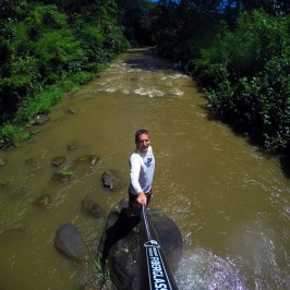 a man standing next to a body of water