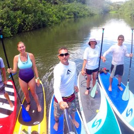 a group of people in a small boat in a body of water