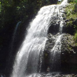 a large waterfall over some water