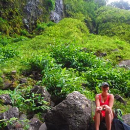 a person sitting on a rock