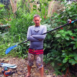 a man standing next to a tree