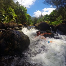 a man riding a wave on top of a rock