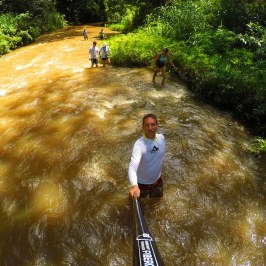 a man standing next to a river