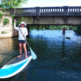 a young man riding a surfboard in the water