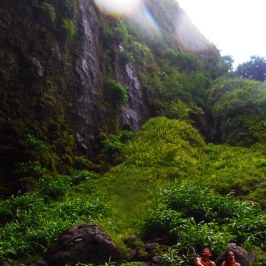 a large waterfall over a rocky cliff
