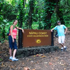 a group of people standing next to a forest