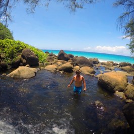 a group of people standing next to a body of water