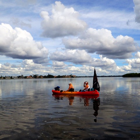 a group of people in a boat on a body of water