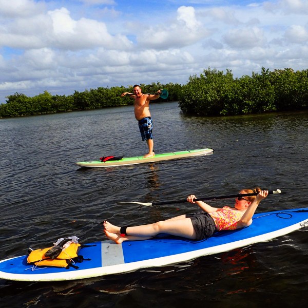 a group of people in a small boat in a body of water