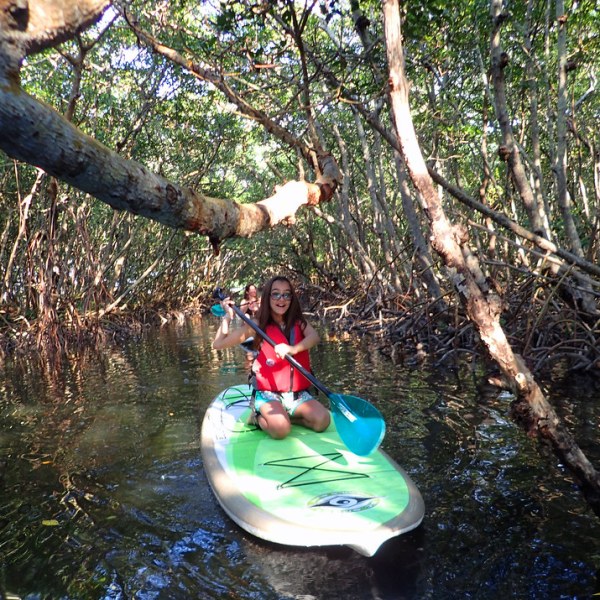 a man holding a frisbee in the water