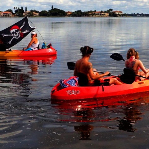 a group of people in a small boat in a body of water