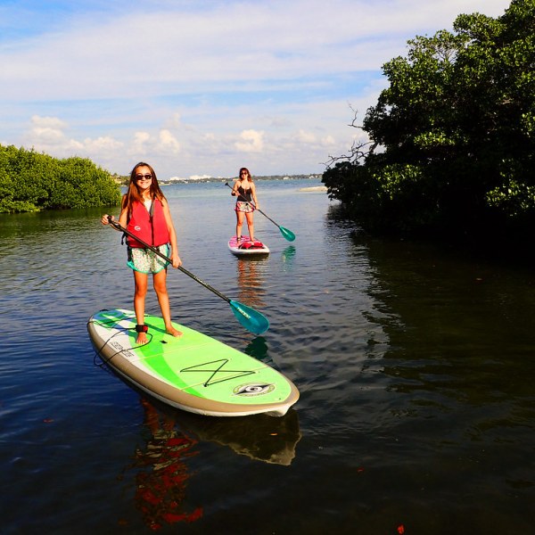 a man standing next to a body of water