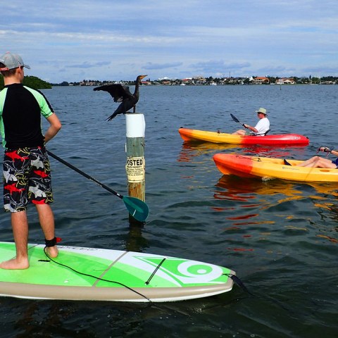 a group of people in a small boat in a body of water
