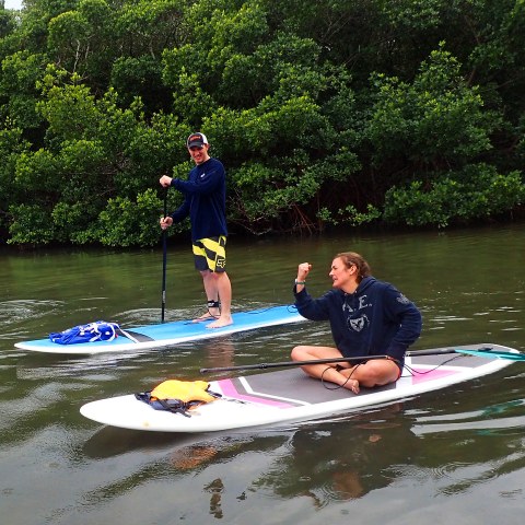 a group of people rowing a boat in the water
