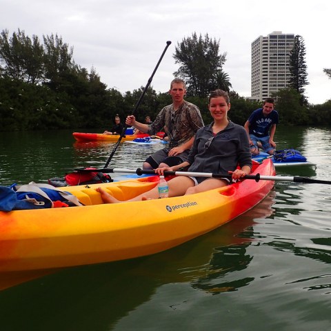 a man riding on the back of a boat in the water