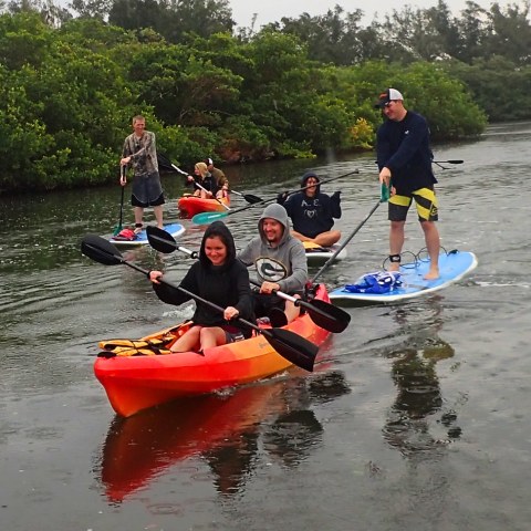 a group of people riding on the back of a boat