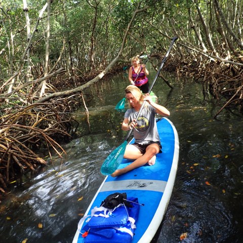 a young person riding a surf board on a body of water