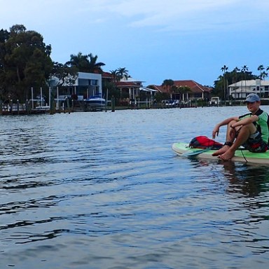 a group of people rowing a boat floating on a body of water