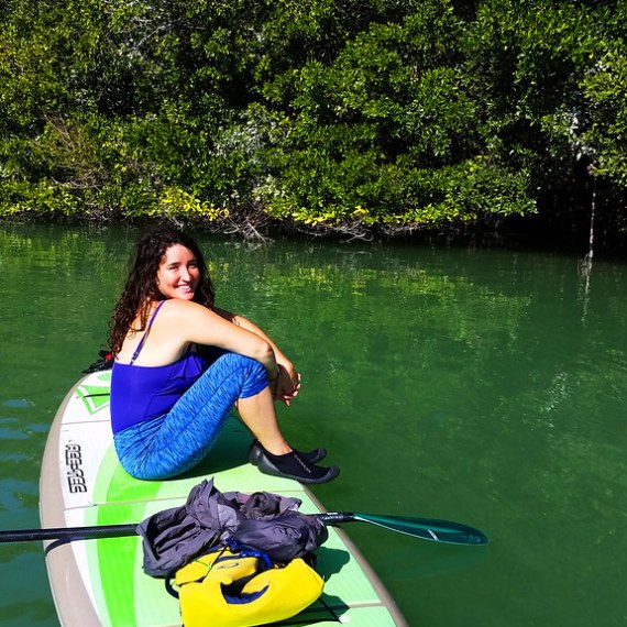 a person sitting next to a body of water