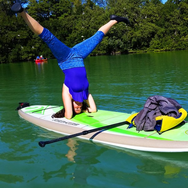 a person riding on the back of a boat in a body of water