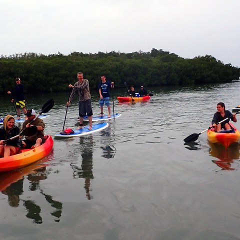 a group of people in a small boat in a body of water