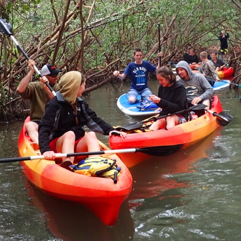 a group of people riding on the back of a boat