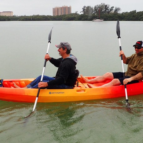 a group of people in a small boat in a body of water